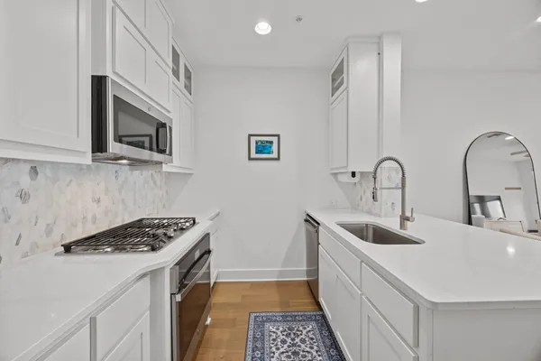 a kitchen that has a sink and a stove