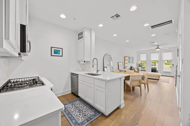 a kitchen with a sink and chairs