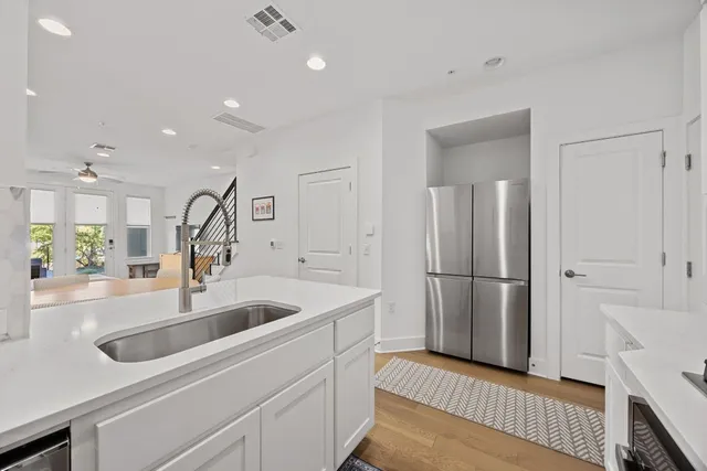 a kitchen with a refrigerator and a sink
