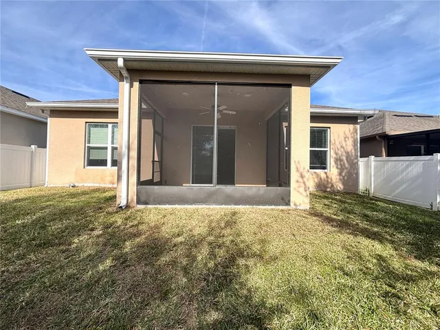 a swimming pool with outdoor seating and a garden