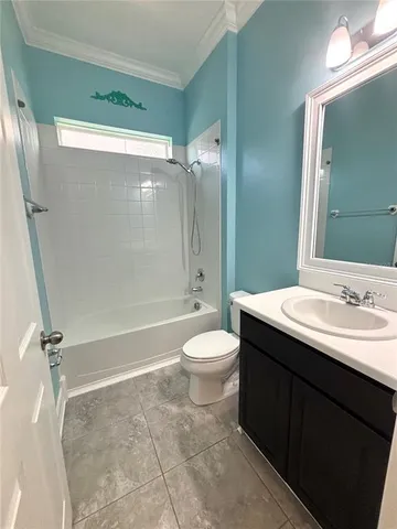 an empty room with a window and a ceiling fan