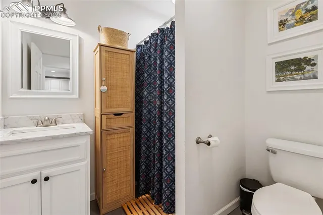 a bathroom with a granite countertop sink toilet and shower