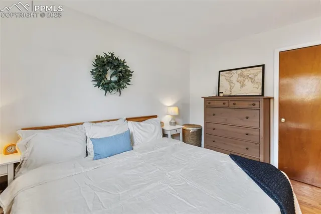 a bedroom with a bed and a painting on the wall