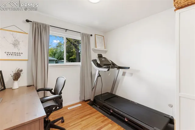 a view of workspace with wooden floor windows