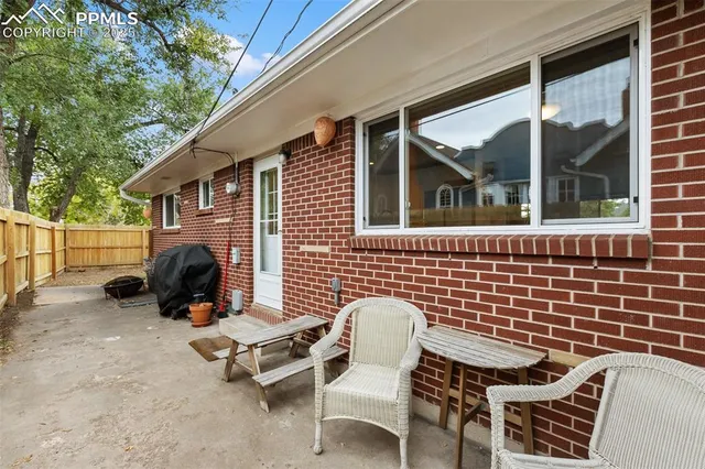 a backyard of a house with table and chairs