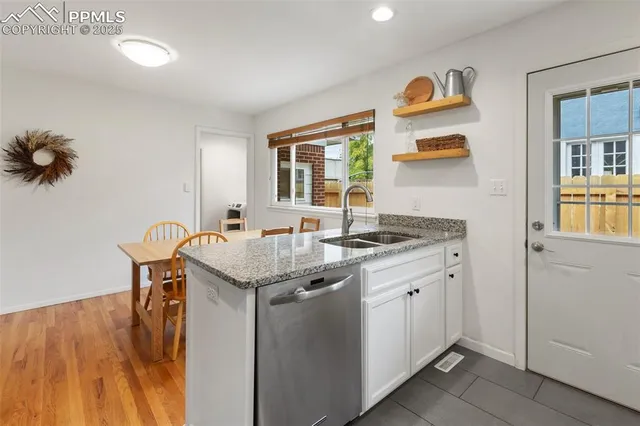 a kitchen with stainless steel appliances granite countertop a sink and cabinets
