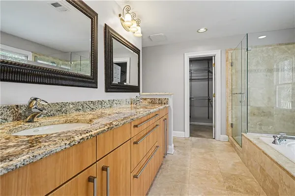 a bathroom with a tub sink and mirror