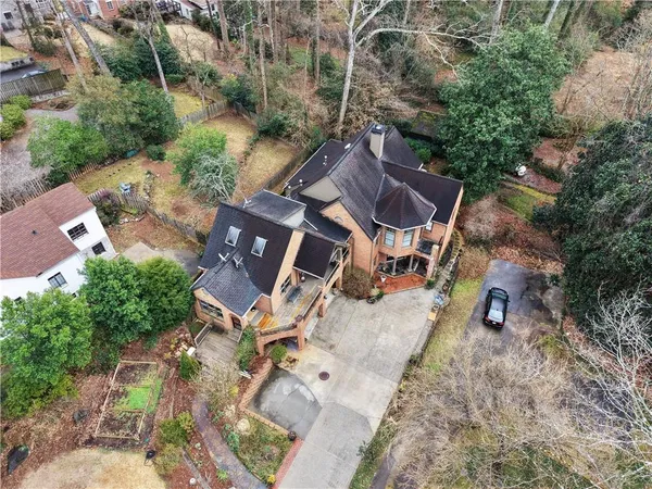 an aerial view of a house with yard and parking
