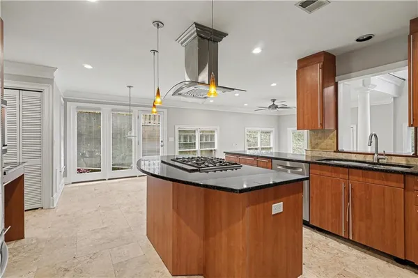 a kitchen with stainless steel appliances granite countertop a sink and a stove