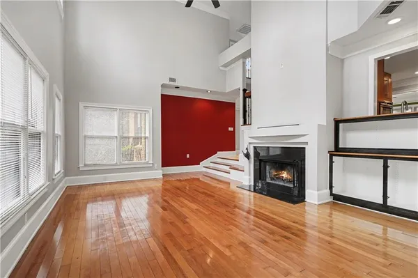 a view of empty room with wooden floor and fireplace