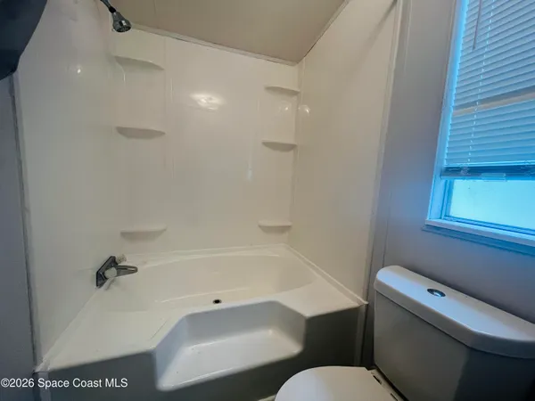 a bathroom with a toilet and a bathtub