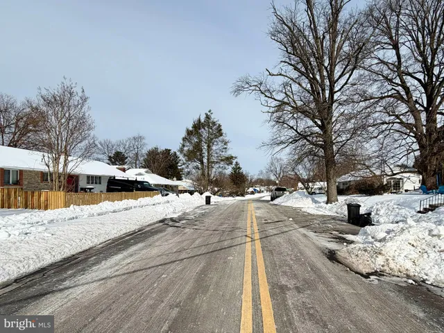 a view of a yard with snow on the road