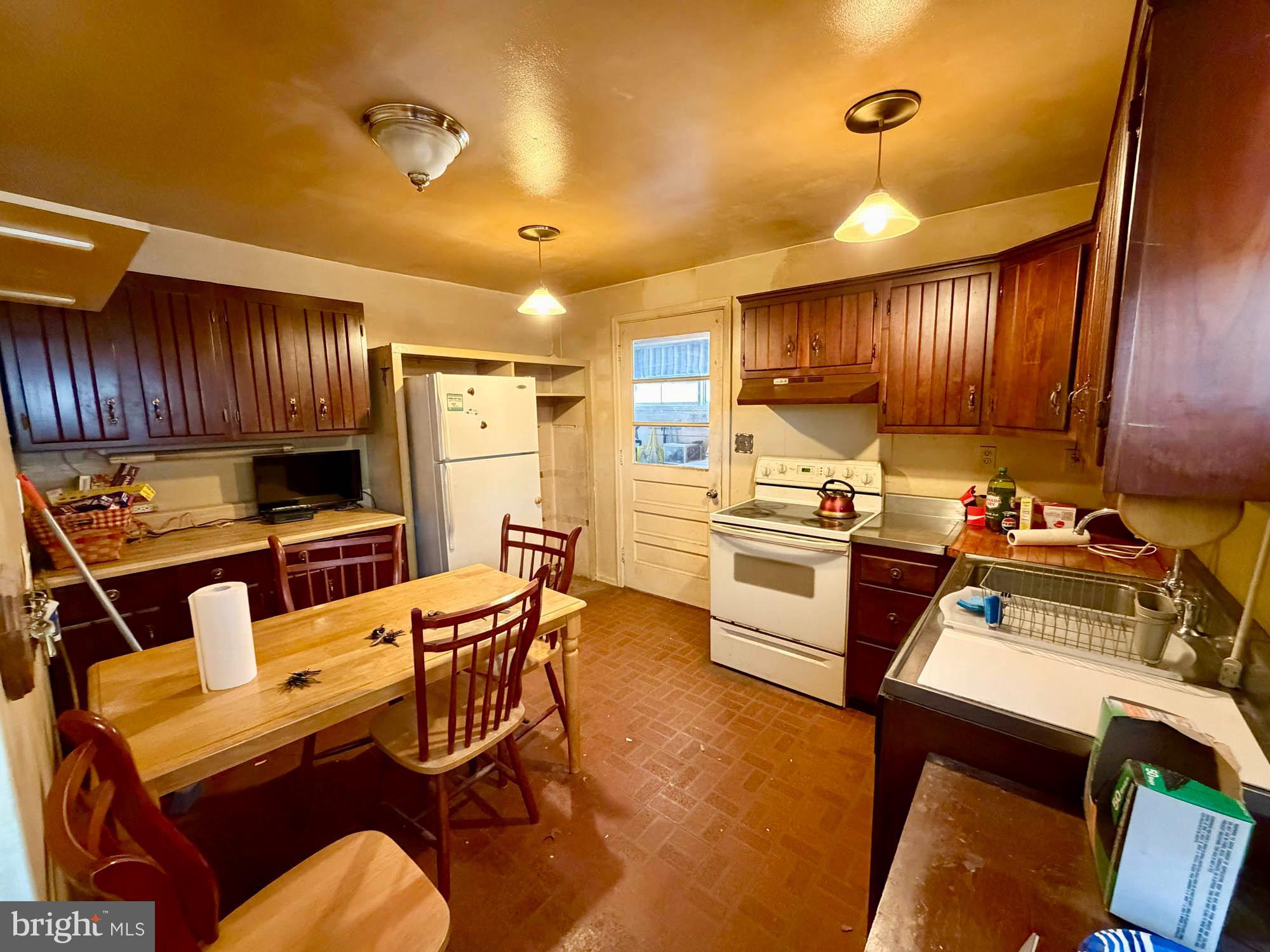 7404 Knollwood Road Baltimore, MD 21286 - Photo 6 of 21 a kitchen with a sink appliances and cabinets