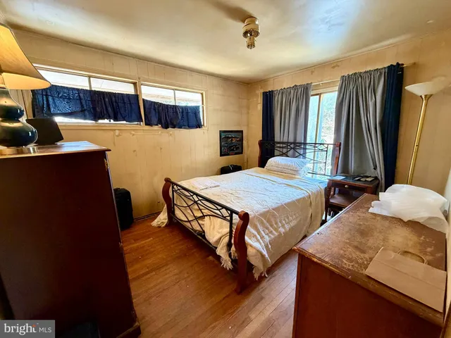 a bedroom with furniture and a window