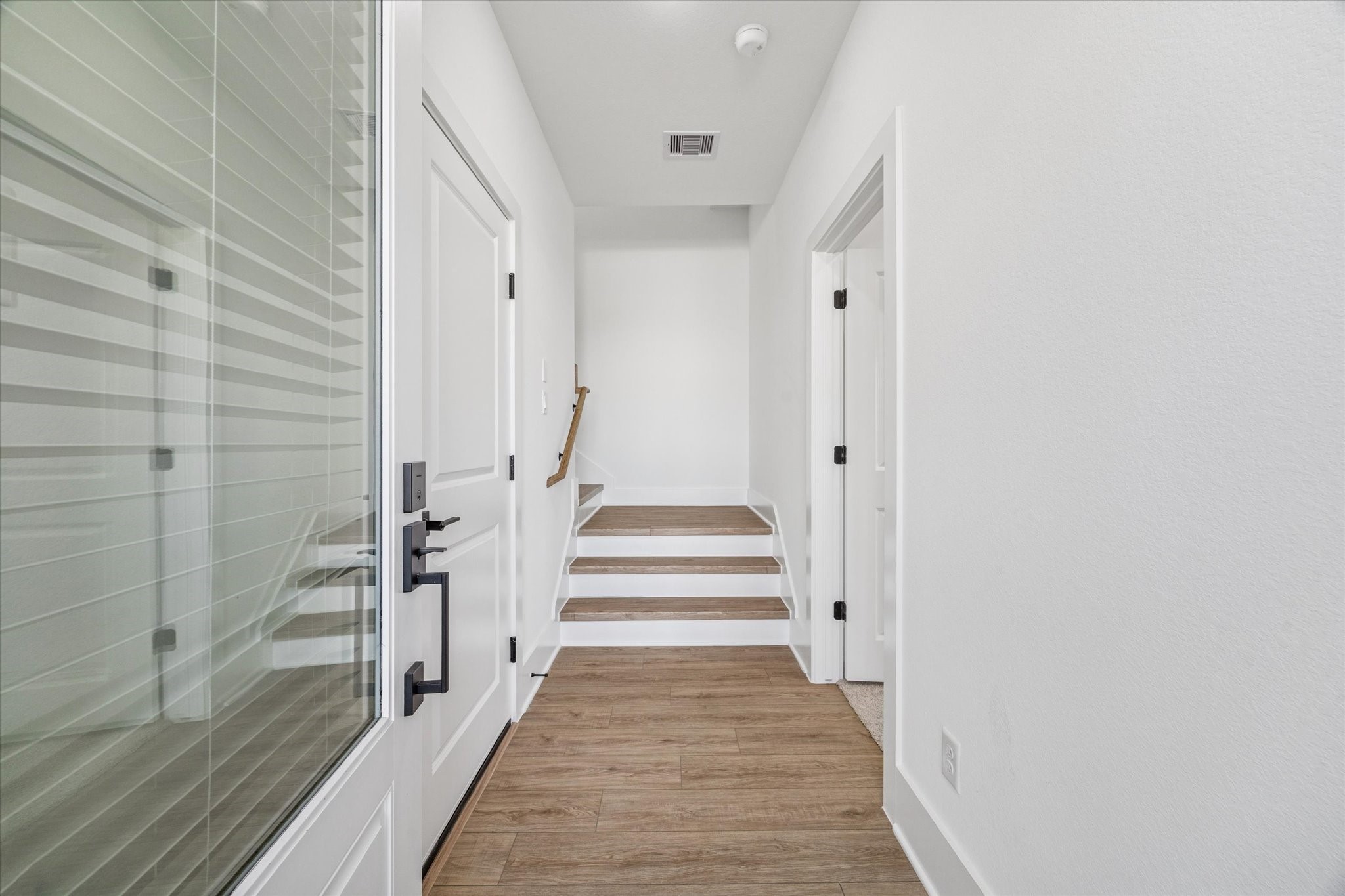 5612 Azores Houston, TX 77091 - Photo 11 of 38 a view of a hallway with wooden floor and staircase