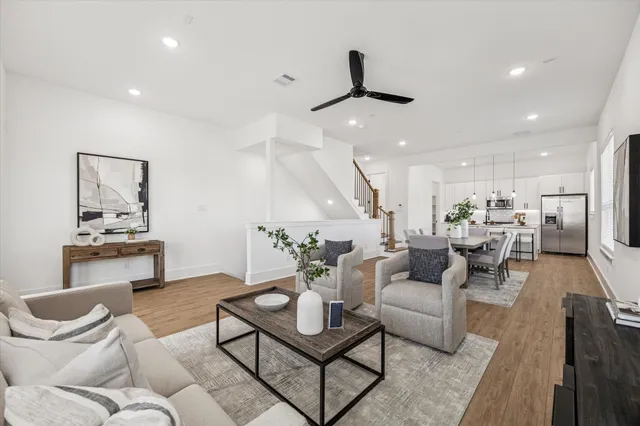 a living room with furniture and kitchen view