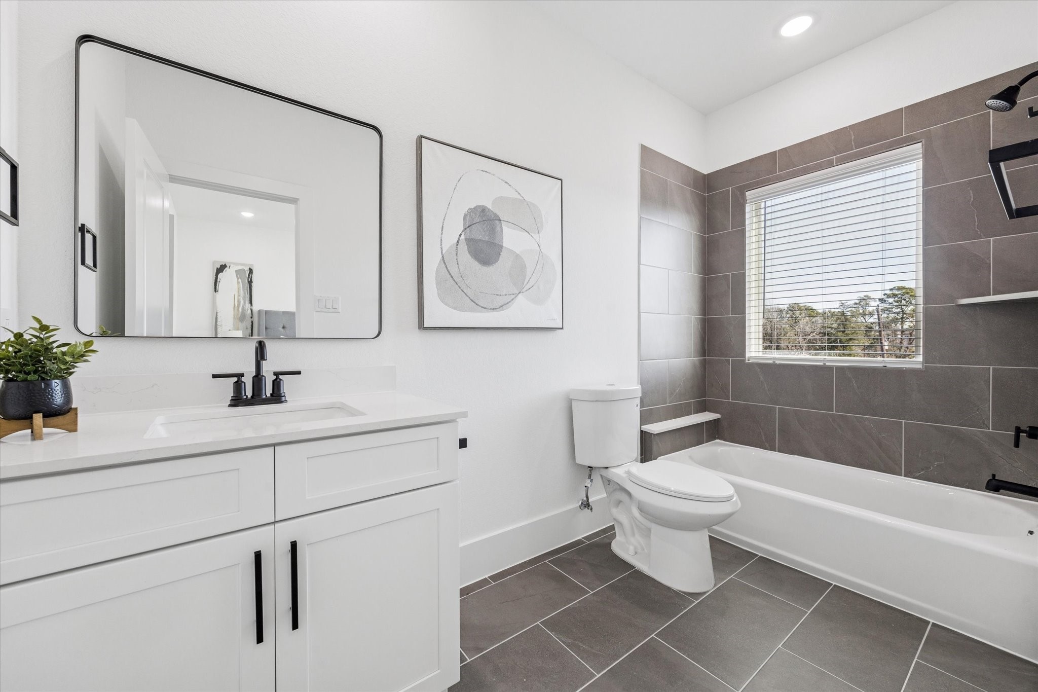 5612 Azores Houston, TX 77091 - Photo 32 of 38 a bathroom with a sink a toilet and a bathtub