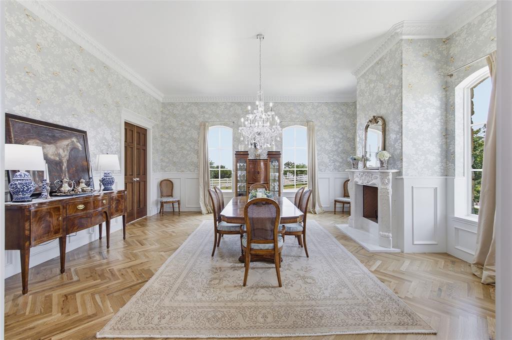 501 Upper Denton Road Weatherford, TX 76085 - Photo 6 of 40 Herringbone wood-finish flooring, ornate chandelier, decorative fireplace, paneled wainscoting, and large windows