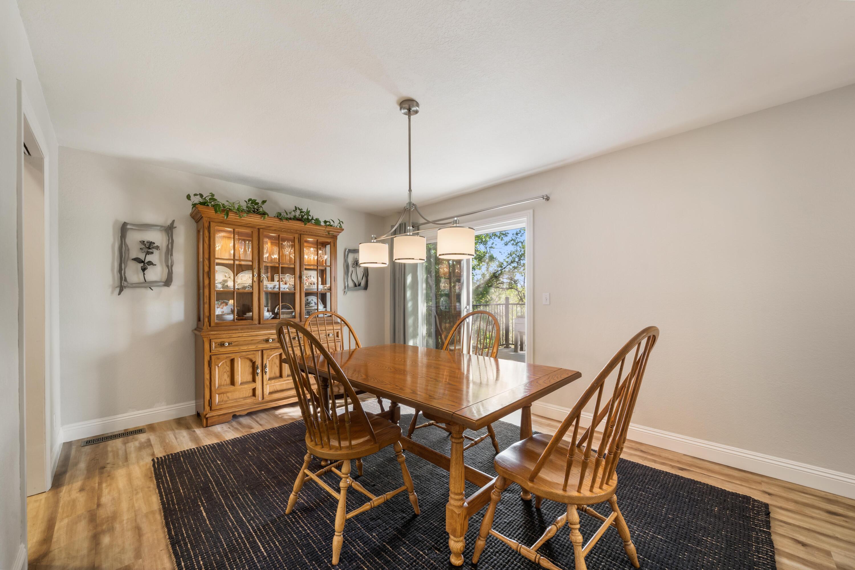 7777 Justice Mine Road Redding, CA 96001 - Photo 16 of 59 a view of a dining room with furniture window and wooden floor