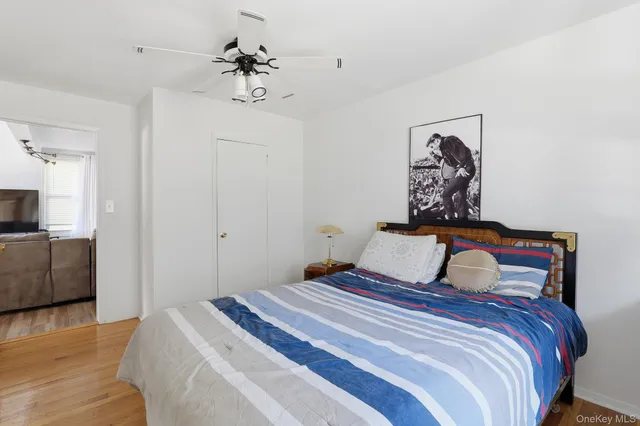 a bedroom with a large bed and a chandelier