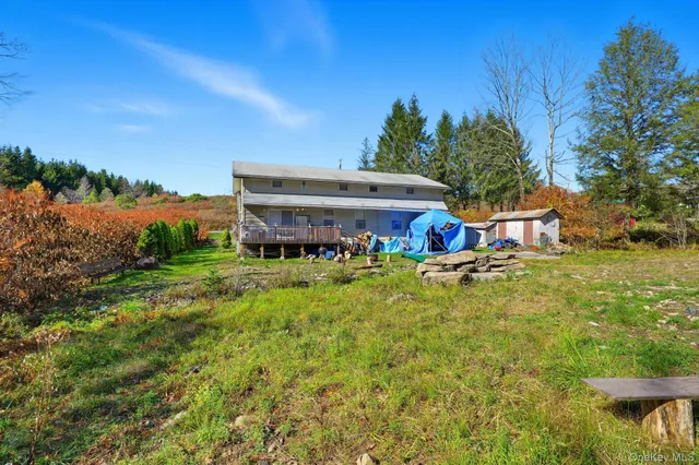 a view of house with outdoor space and seating area