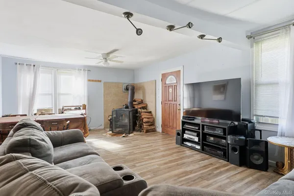 a living room with furniture ceiling fan and a wooden floor