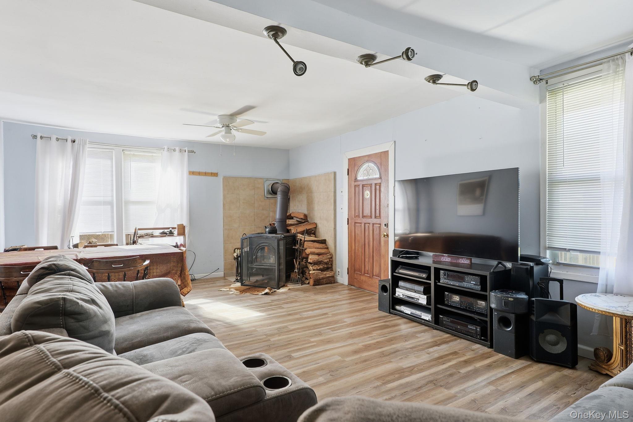284 Bonnie Brook Road Roscoe, NY 12776 - Photo 4 of 25 a living room with furniture ceiling fan and a wooden floor