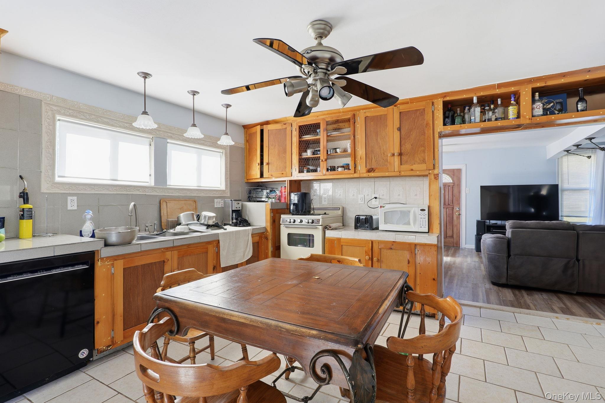 284 Bonnie Brook Road Roscoe, NY 12776 - Photo 8 of 25 a kitchen with a stove a sink and a refrigerator