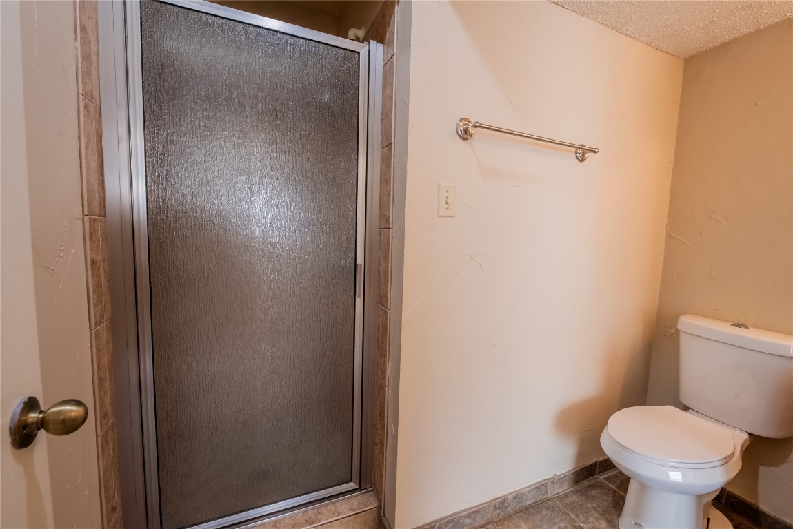 806 West 24th Street, Unit 320 Austin, TX 78705 - Photo 10 of 14 a white toilet sitting next to a shower