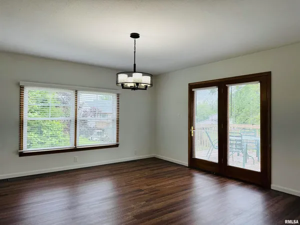 a kitchen with stainless steel appliances granite countertop a stove a microwave and a white cabinets