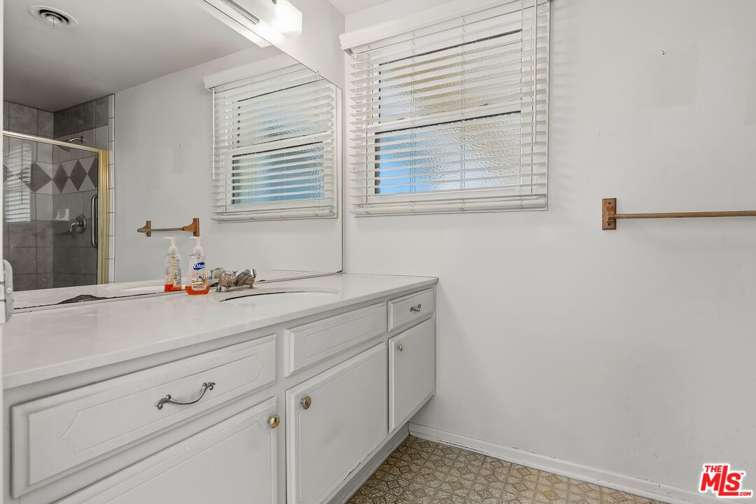 19131 Tulsa Street Porter Ranch, CA 91326 - Photo 26 of 43 a bathroom with a sink and a mirror