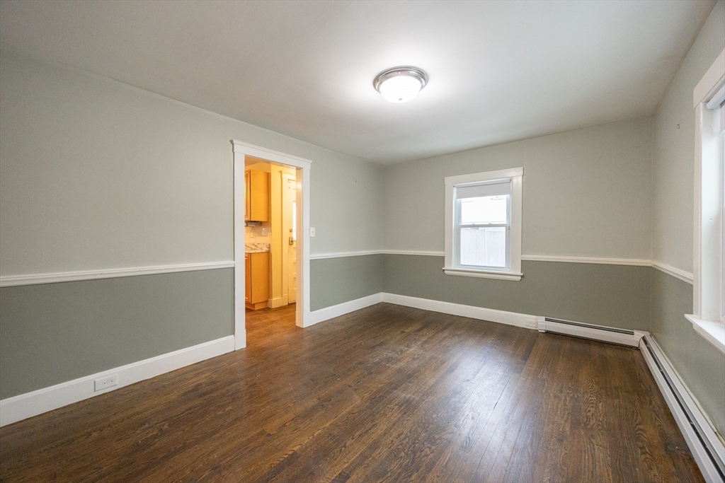 21 Manning Street Salem, MA 01970 - Photo 14 of 26 an empty room with wooden floor and windows