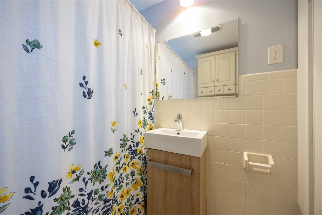 21 Manning Street Salem, MA 01970 - Photo 26 of 26 a bathroom with a sink a mirror and a shower