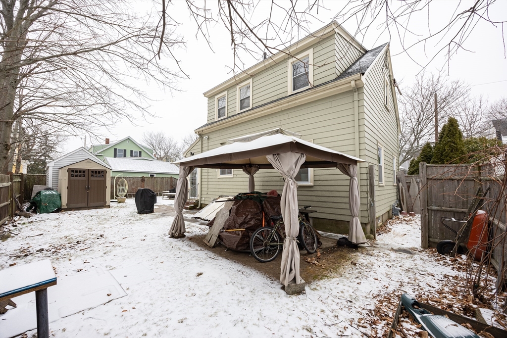 21 Manning Street Salem, MA 01970 - Photo 4 of 26 a view of a house with a yard covered in snow