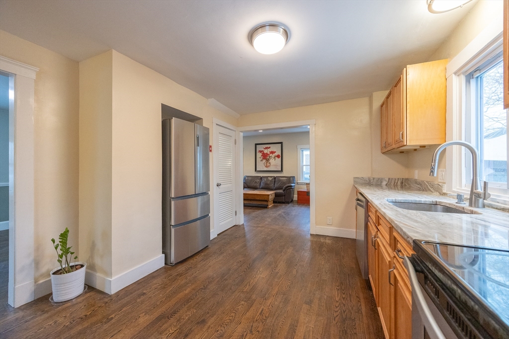 21 Manning Street Salem, MA 01970 - Photo 9 of 26 a kitchen with kitchen island wooden floor center island and stainless steel appliances
