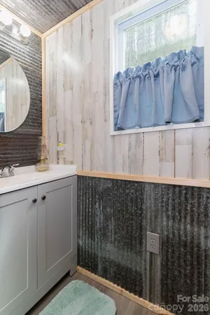 a bathroom with a sink a mirror and a shower
