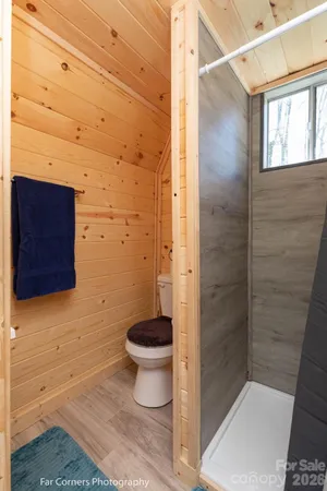 a bathroom with a toilet and a shower