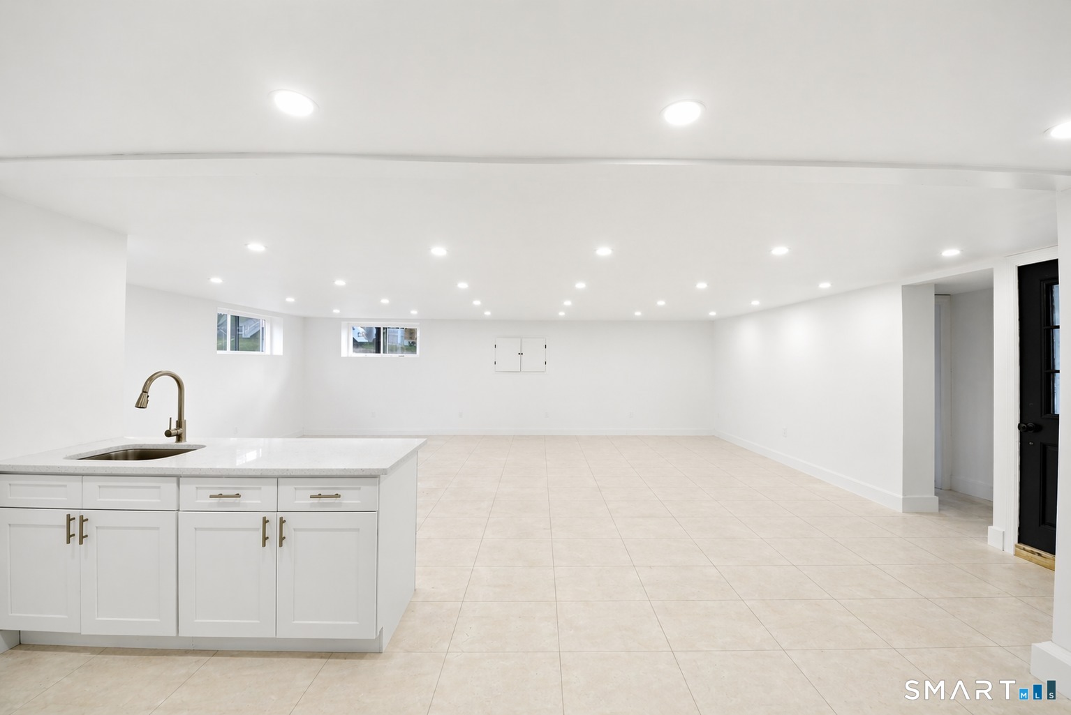 12 Darien Road New Fairfield, CT 06812 - Photo 20 of 31 Basement w/ wet bar/recreation room, laundry room, storage room, and full bathroom.