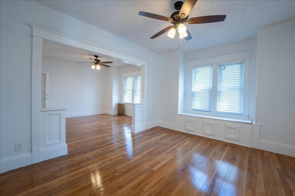 28 Fairmount Street Springfield, MA 01108 - Photo 6 of 42 a view of empty room with wooden floor and fan