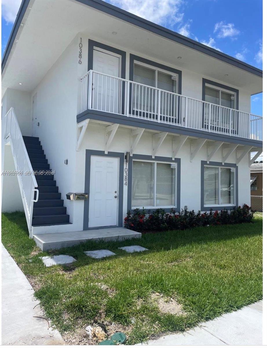 10384 Southwest 173rd Street, Unit 2 Miami, FL 33157 - Photo 1 of 12 a view of a house with a yard