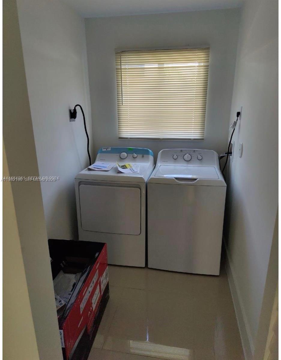 10384 Southwest 173rd Street, Unit 2 Miami, FL 33157 - Photo 8 of 12 a view of storage and utility room with washer and dryer