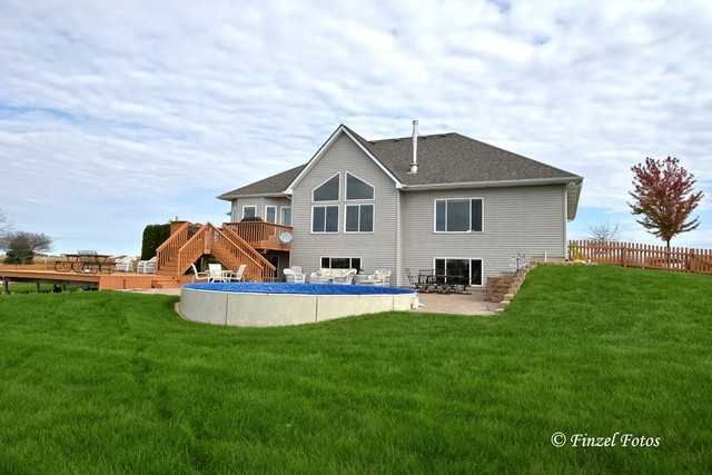30813 Lincoln Road Genoa, IL 60135 - Photo 18 of 20 a front view of a house with a yard and trees