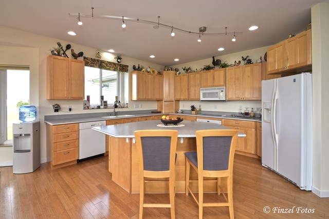 30813 Lincoln Road Genoa, IL 60135 - Photo 8 of 20 a large kitchen with kitchen island granite countertop wooden floors and white cabinets