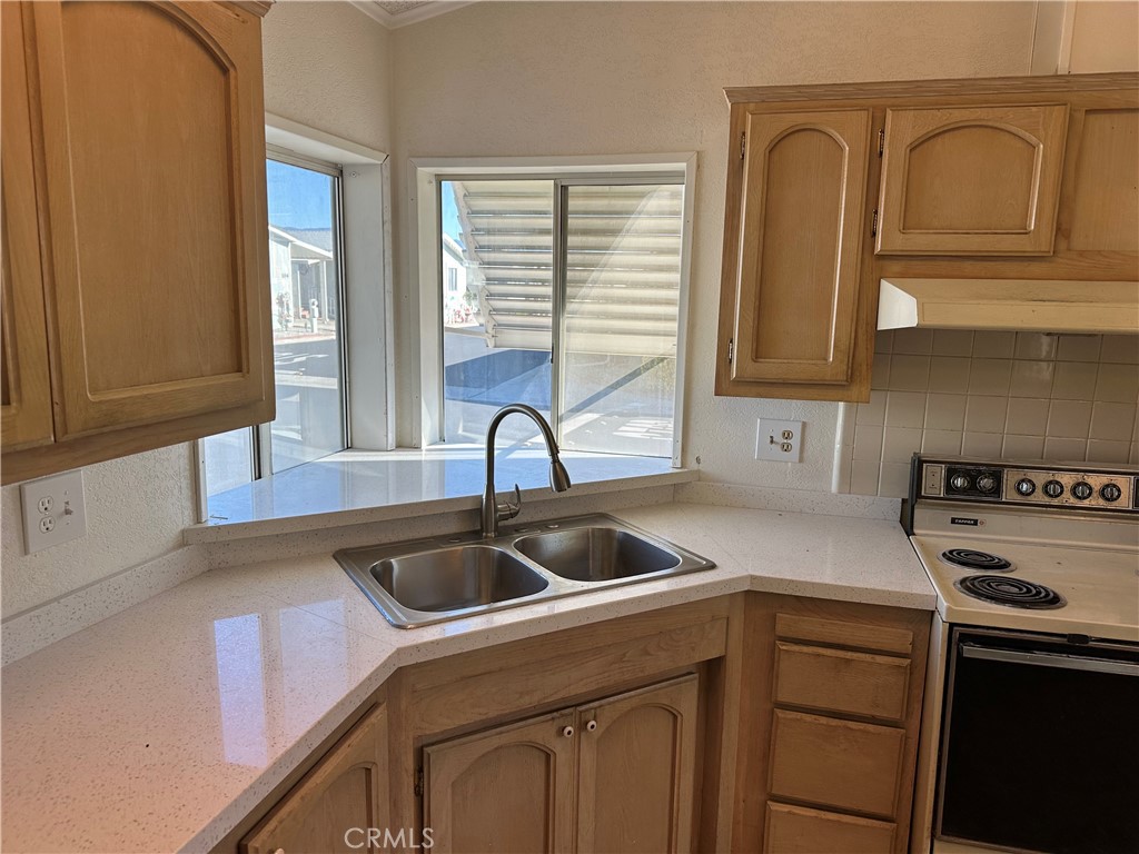 a kitchen with a sink cabinets and stainless steel appliances