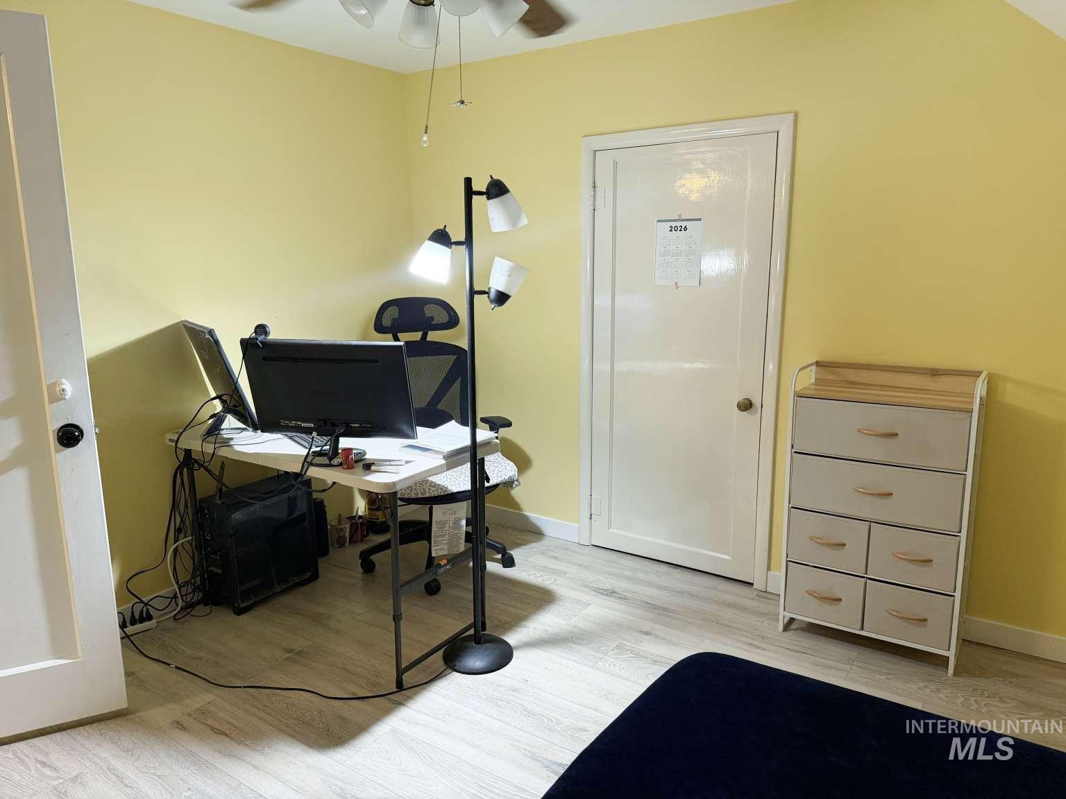 1158 South Powerline Road Nampa, ID 83686 - Photo 33 of 46 Room featuring light-colored wood-finish flooring, a ceiling fan with integrated lighting, and white baseboards