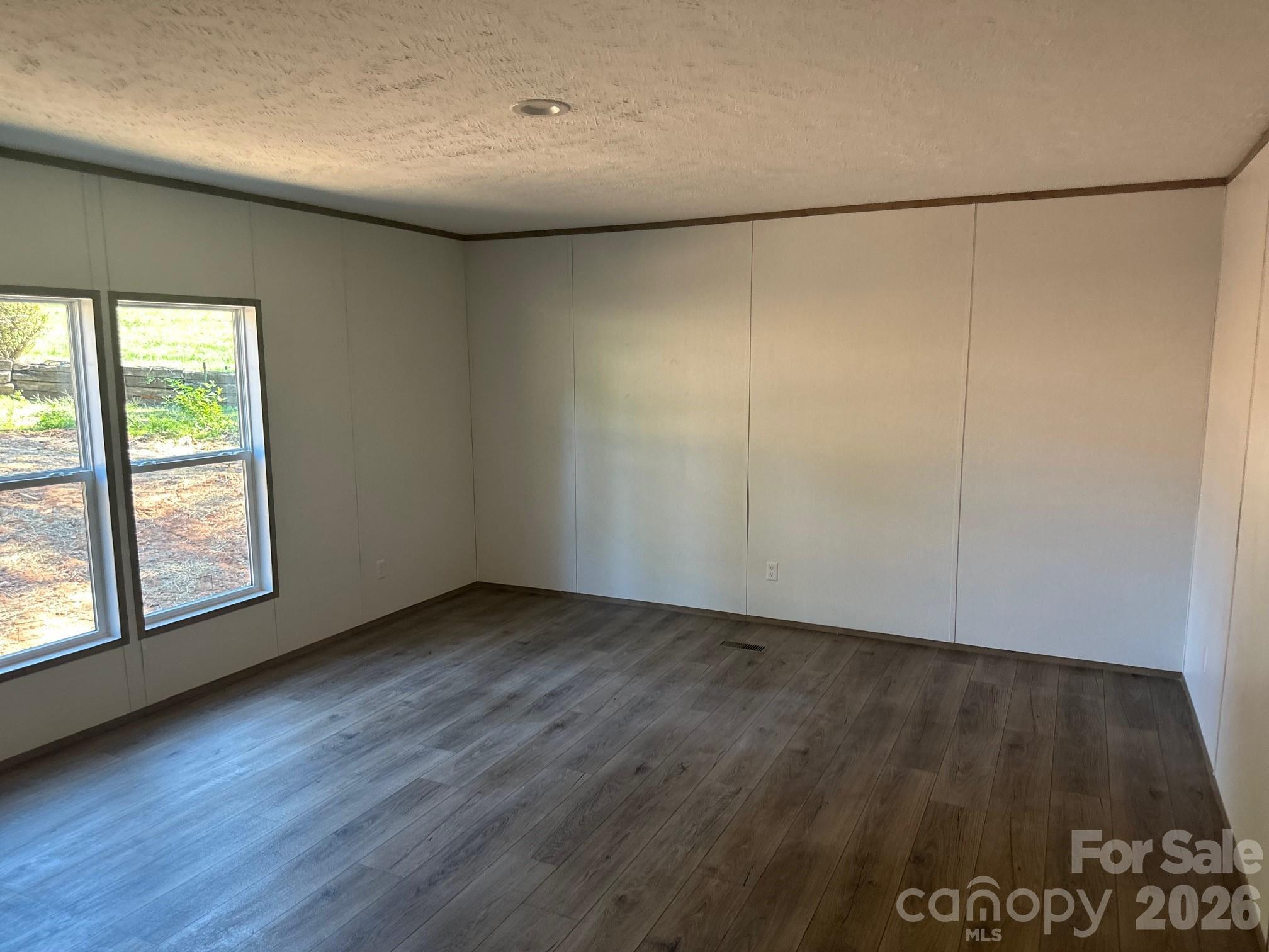 178 Clear Springs Road Mooresville, NC 28115 - Photo 6 of 13 an empty room with wooden floor and windows