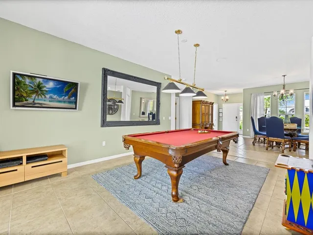 a bedroom with furniture pool table and a rug