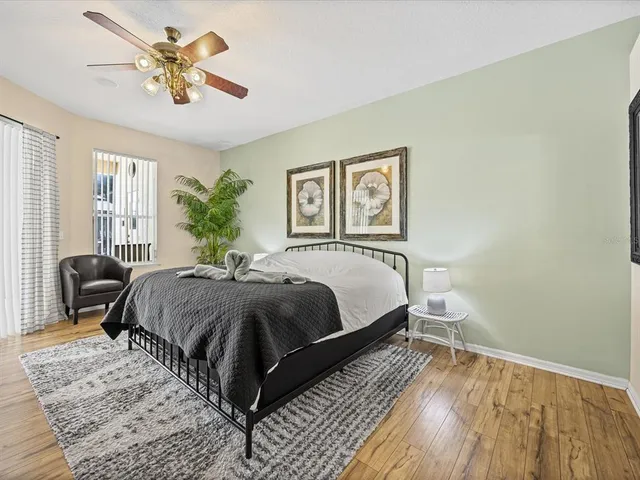 a bedroom with a bed and wooden floor