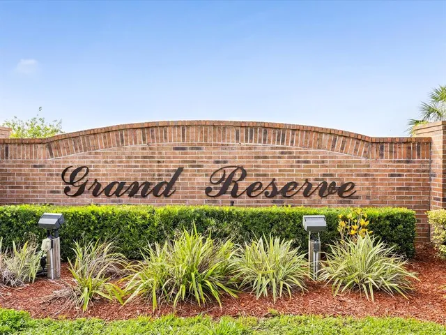 a street sign on a wall next to a road
