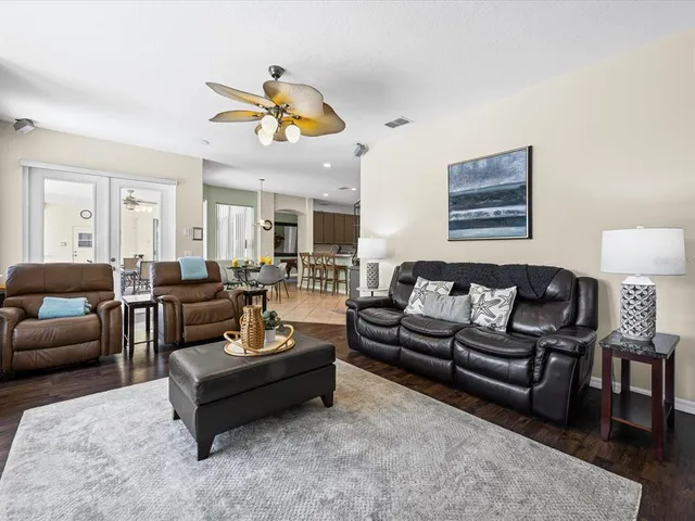 a living room with furniture kitchen view and a table